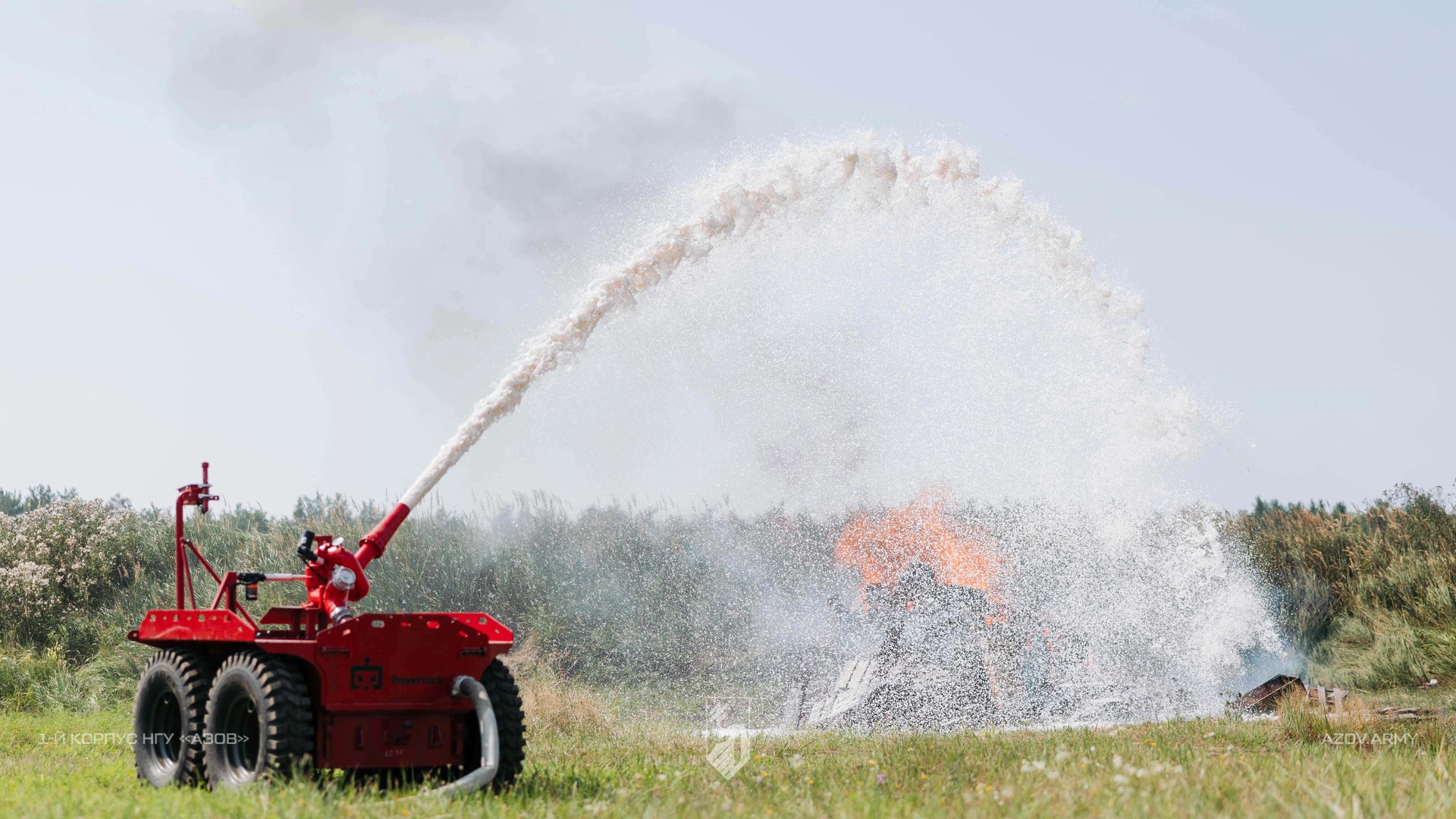 Operator controls a firefighting UGV while extinguishing a fire